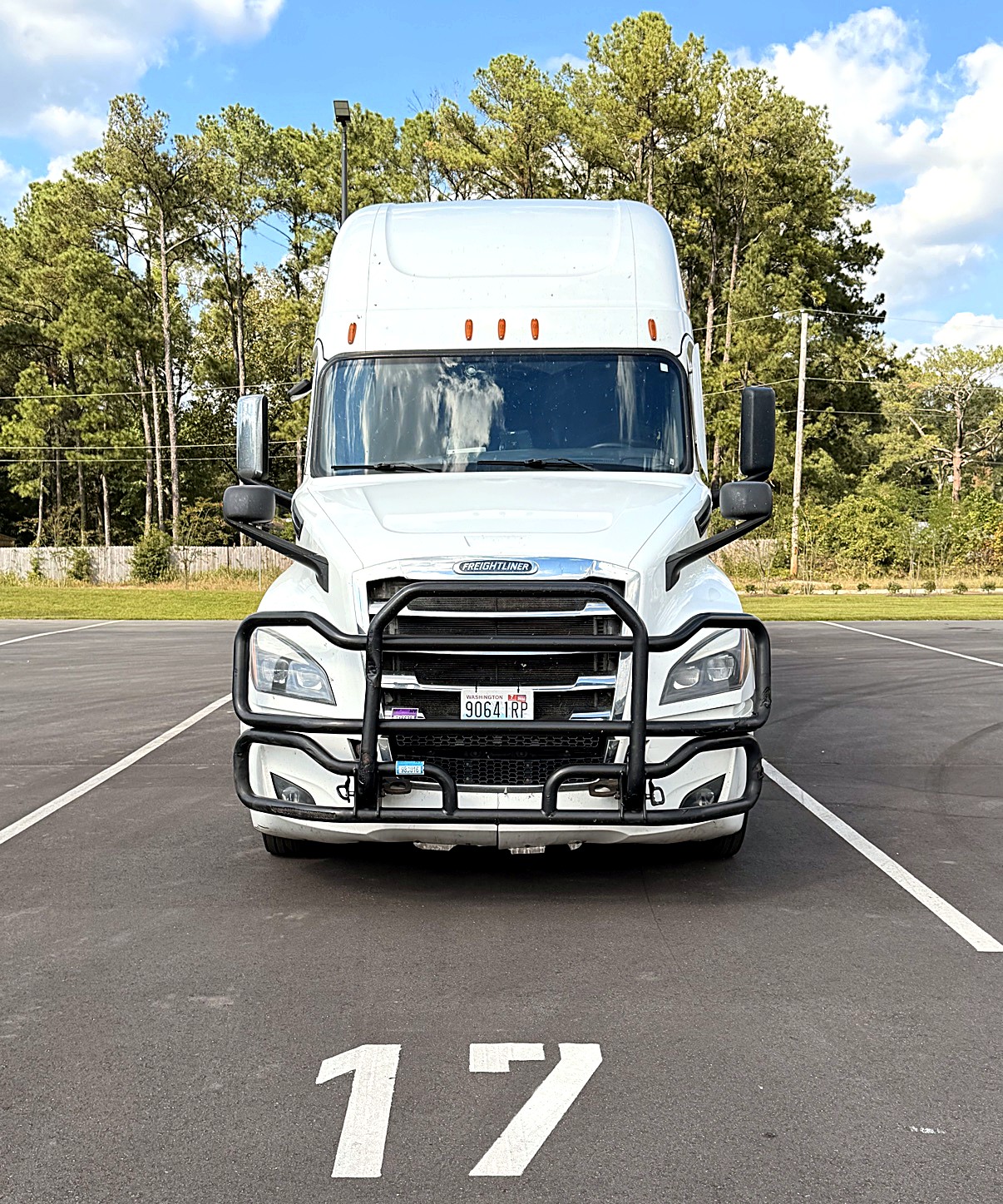 White Oneway Group Freightliner Cascadia head-on in parking spot 17 with Washington plate 90641RP